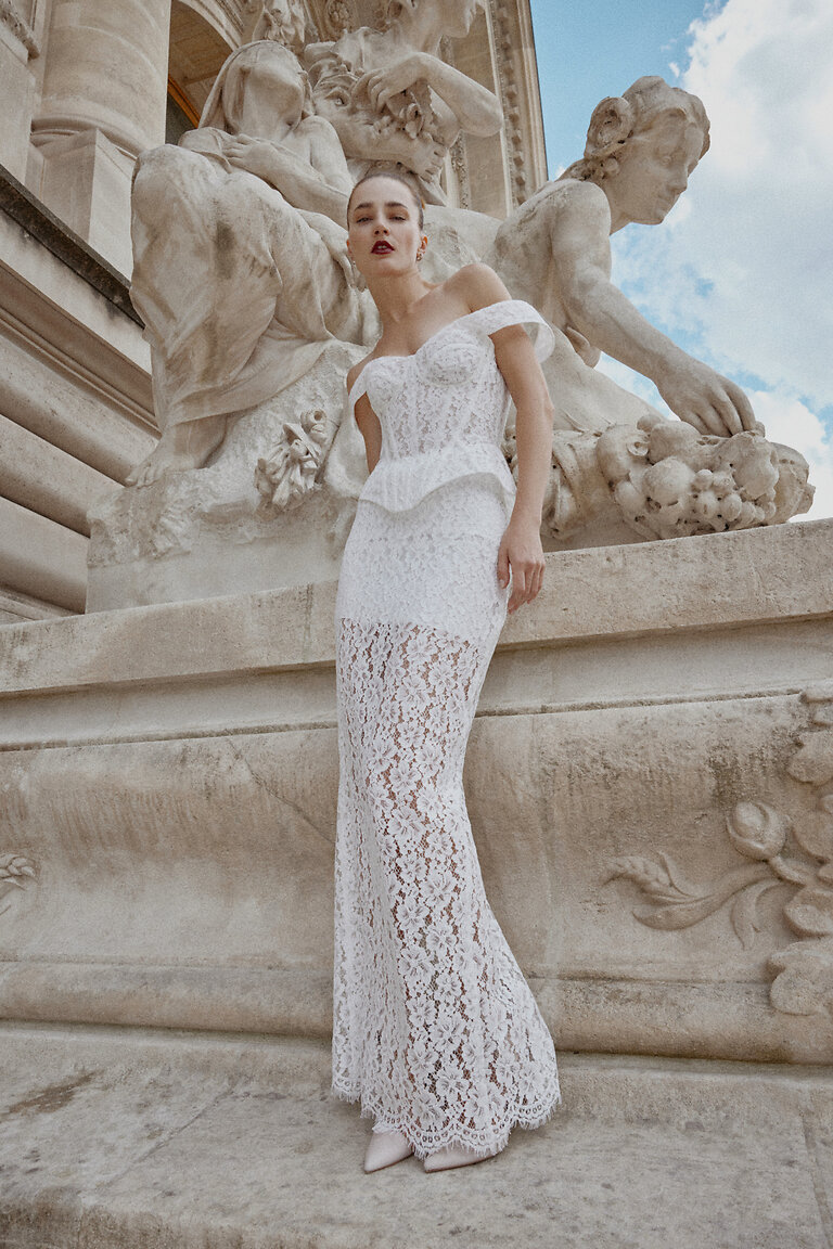 Full-body view of Pippa off-white lace wedding dress by Unona. Fitted sheath silhouette with a sheer scalloped hem.