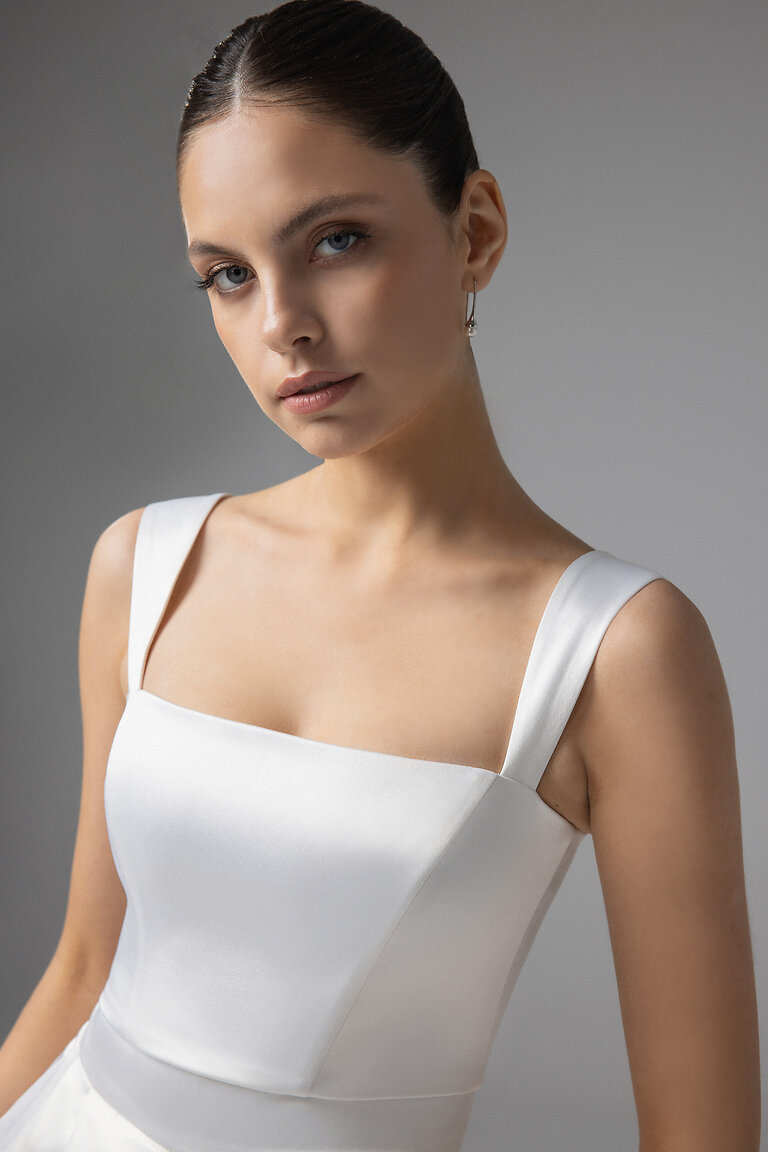 Close Up of Andrea Top Square Neckline Close up front view of Andrea ivory stretch satin crop top showcasing the modern square neckline and supportive wide straps.