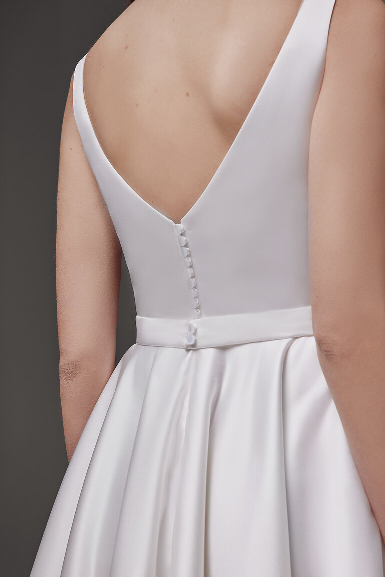 Romantic V-Back Detail of Vlada Midi Gown Detail of the Vlada off-white midi dress back showing a romantic V-back and functional satin-covered buttons