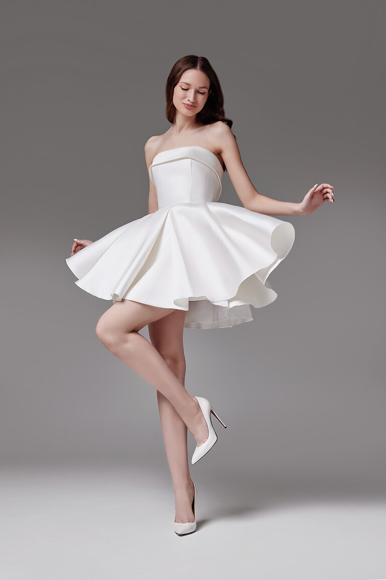 Full length front view of the short ivory Sophie mini reception dress in luxurious mikado with deep pleats.