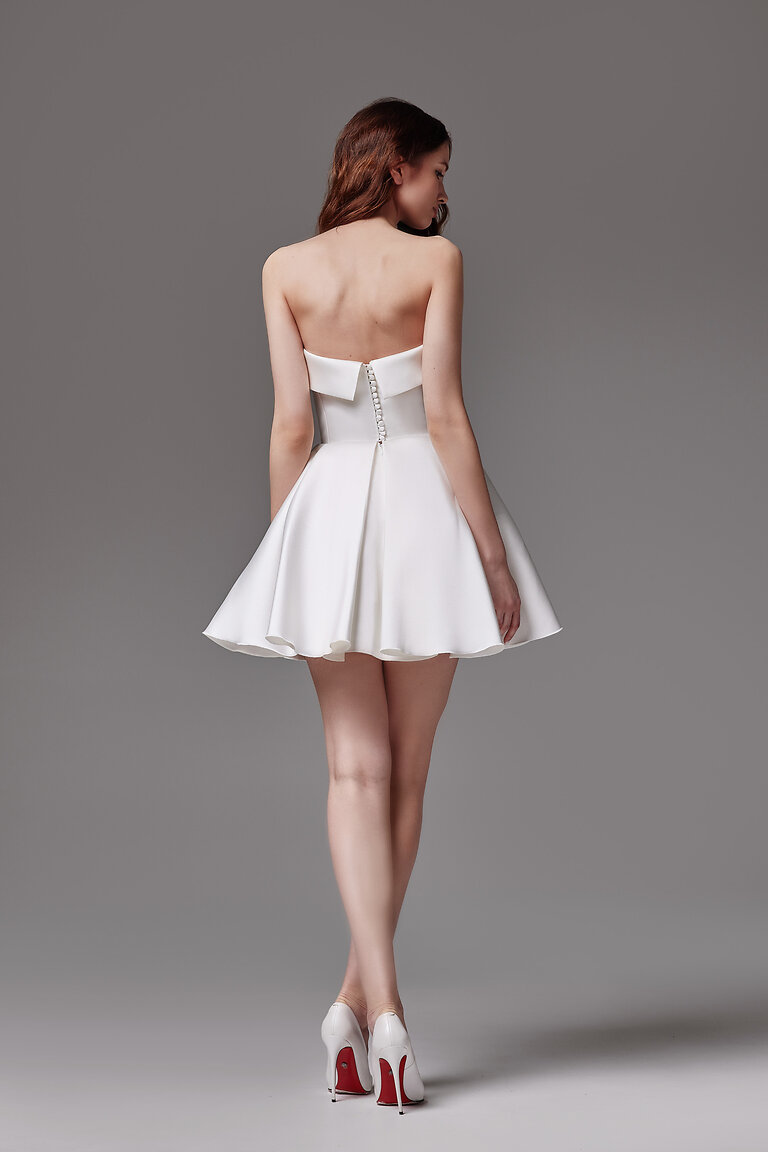Full back view of the short Sophie mini wedding dress in ivory mikado showing strapless open back and pleats.