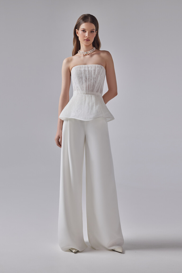 Full-body look of Riki modern bridal suit showing strapless corset bodice with semi-sheer lace boning and wide-leg pants