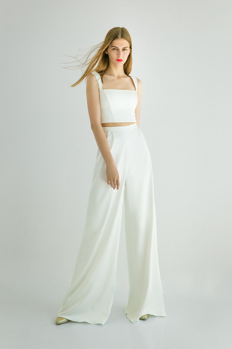 Andrea Bridal Top for Engagement Party Andrea fitted ivory satin crop top with wide straps styled with trousers for a chic engagement party or reception look.