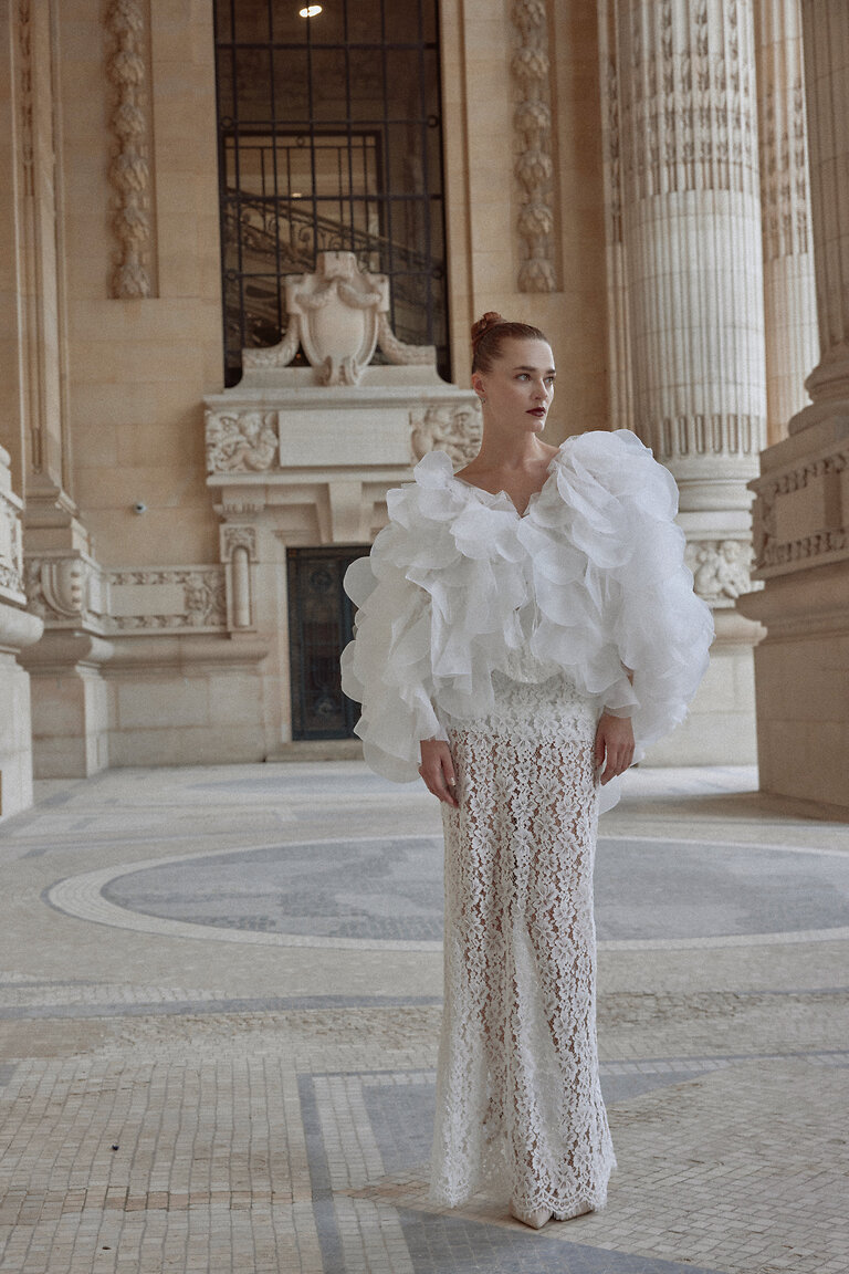 Voluminous Organza Bridal Cape Front View Front view of the Medea off-white organza bridal cape, a sheer ruffled wrap adding romantic volume to a wedding dress.