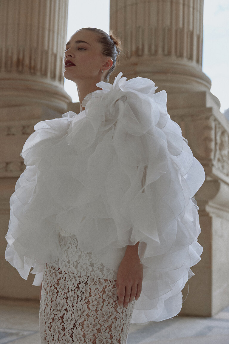 Elegant Detachable Wedding Cape Medium shot of the detachable Medea cape, an off-white organza bridal accessory providing elegant volume and texture.