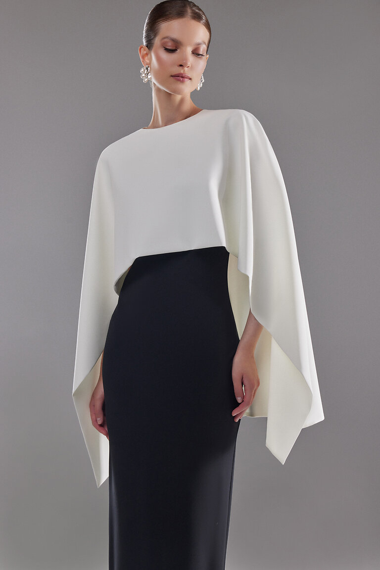 Chic Ivory Bridal Cape Styled as Modern Separates Ivory stretch crepe Cape Ell by Unona styled over a contrasting black skirt highlighting its modern minimalist design.