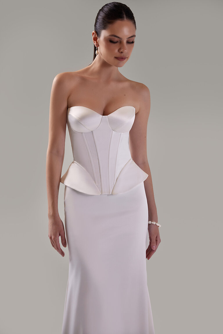 Structural Boning & Peplum Waist Detail Gina ivory corset bodice featuring structural vertical boning, molded cups, and modern peplum waist in studio.