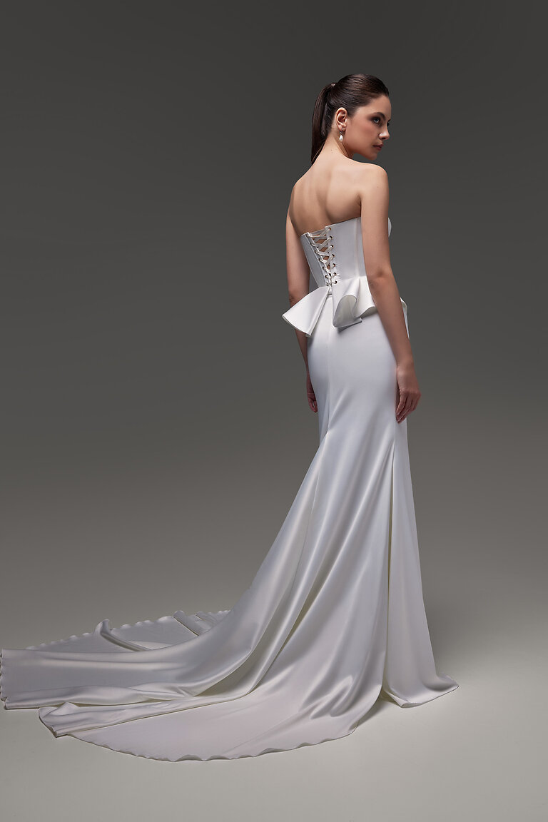 Dramatic Chapel Train Gina Skirt Back studio view of the Gina Skirt by Unona. Minimalist ivory bridal skirt featuring a dramatic chapel train.