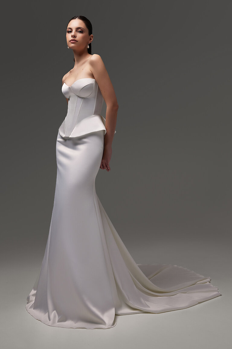 Gina Bridal Skirt Studio View Ivory Studio shot of the Unona Gina Skirt. Ivory stretch satin bridal skirt with a fitted mermaid silhouette and long hem.