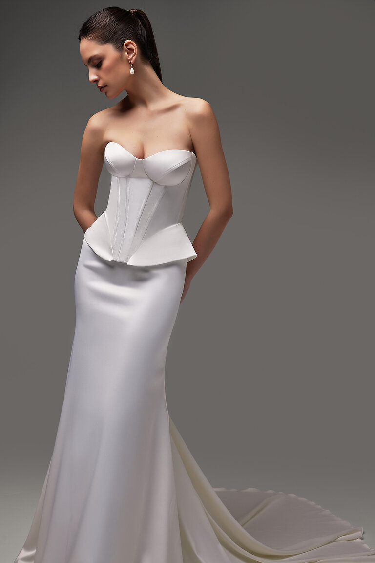 Versatile Gina Corset Bridal Separates Full length studio shot of Gina ivory satin bridal corset with modern peplum waist, styled with long train skirt.