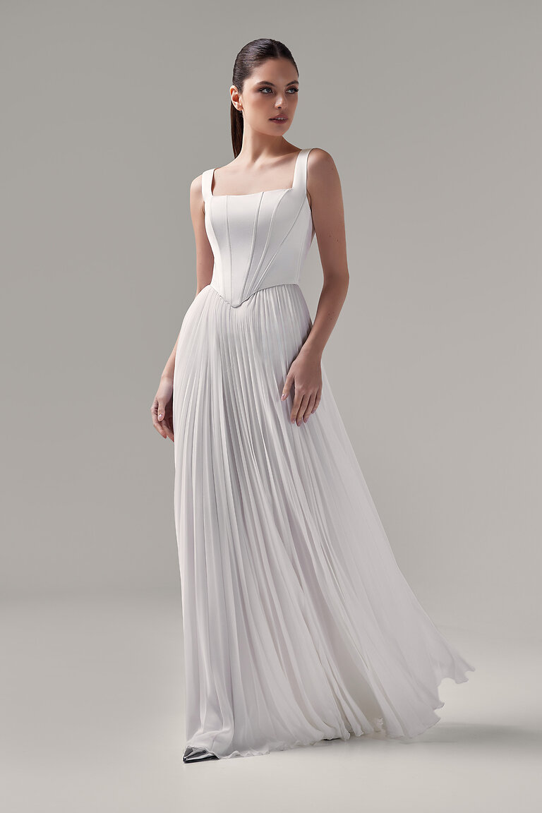 Elegant Casia Bridal Corset Styled with a Flowing Skirt Full length look of the Casia Corset in ivory satin by Unona, styled with a pleated skirt. Features a classic square neck.