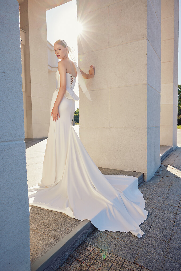 Gina Skirt Chapel Train Back Detail Back view of Gina bridal skirt in ivory stretch satin featuring a stunning chapel train and mermaid silhouette.