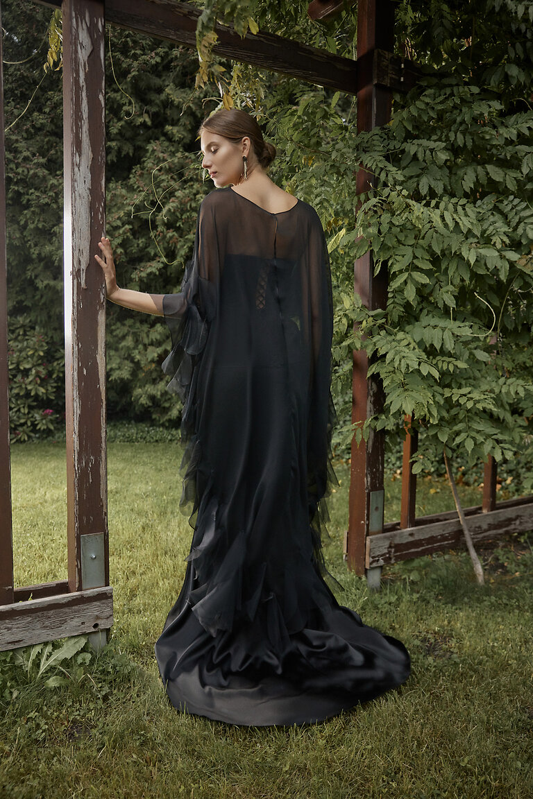 Ditta Floor-Length Chiffon Cape Back View Back view of the elegant Unona Ditta black chiffon cape showcasing its sheer drape and floor-length silhouette.