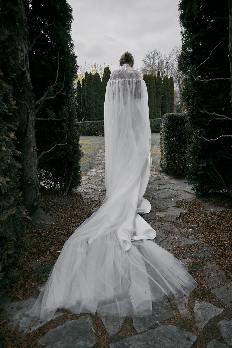 Sheer Tulle Chapel Train Bridal Cape Full back view of Evelyn off-white wedding cape showing sheer tulle chapel train and delicate lace button closure.