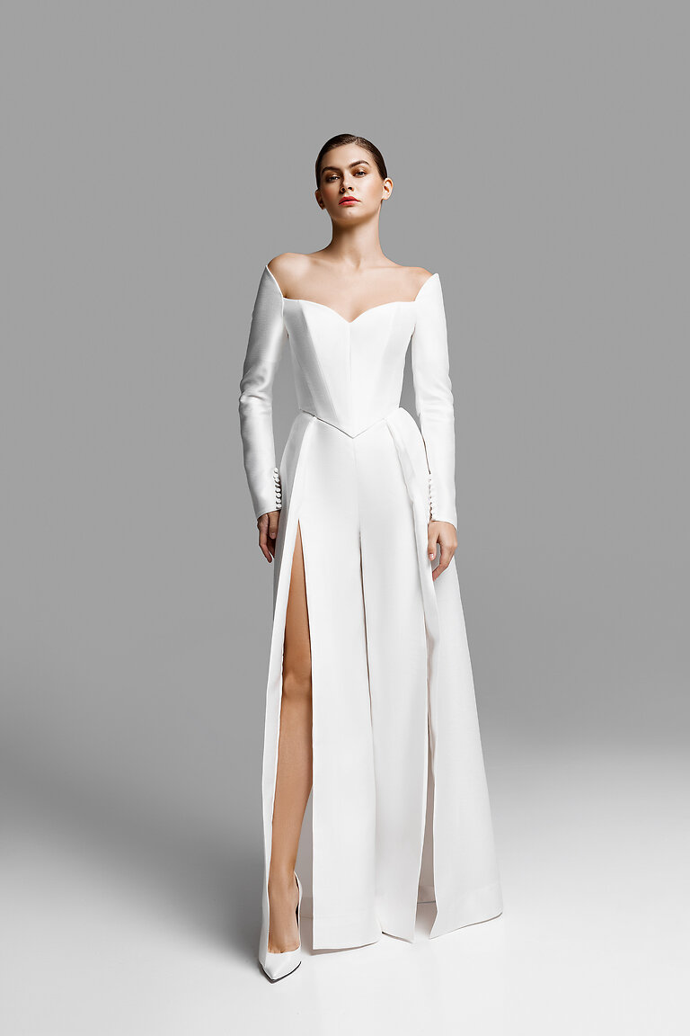 Roxana Off The Shoulder Bridal Corset Full length view of the Roxana ivory off the shoulder corset top by Unona with long sleeves and pointed basque waist.