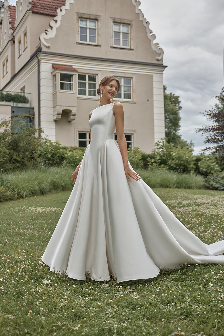 Classic Sleeveless Mikado Bridal Gown by Unona Full length view of the Marine sleeveless ivory mikado bridal gown showing the classic A-line silhouette and chapel train.
