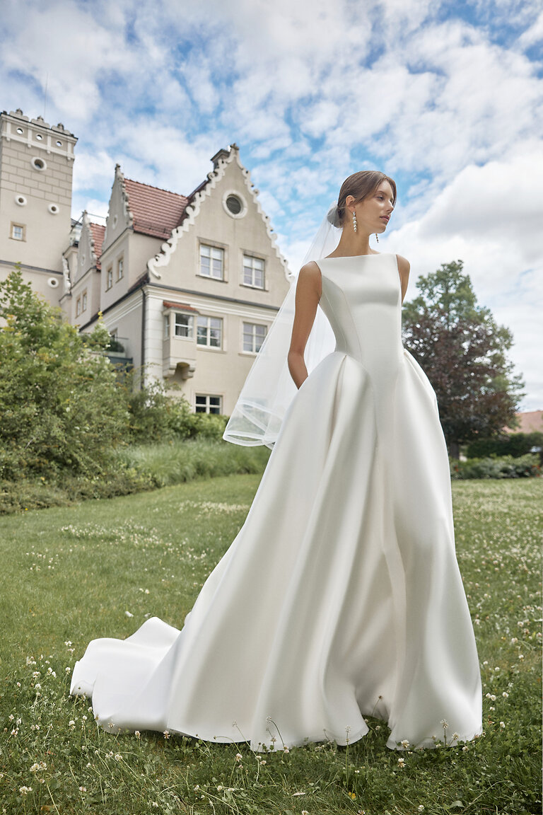 Marine Ivory A-Line Wedding Dress with High Neckline Marine ivory mikado A-line wedding dress by Unona featuring a high neck, drop waist, and side pockets.
