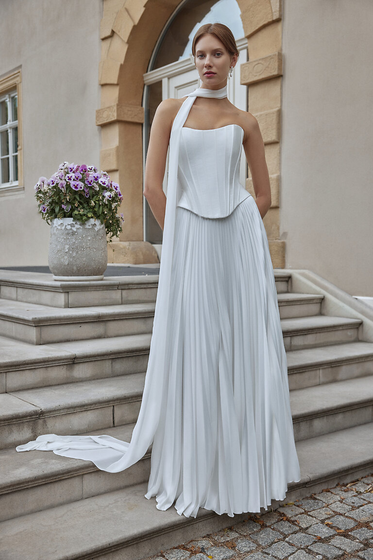 Full Length Ellora A-Line Wedding Dress Full length of Ellora off-white A-line wedding dress featuring basque waist and pleated silk skirt.