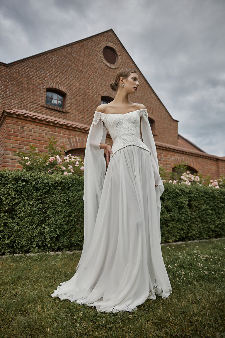 Leona Romantic Two-Piece Wedding Dress Front View Unona Leona ivory two-piece wedding dress with basque waist corset and long chiffon sleeves front view
