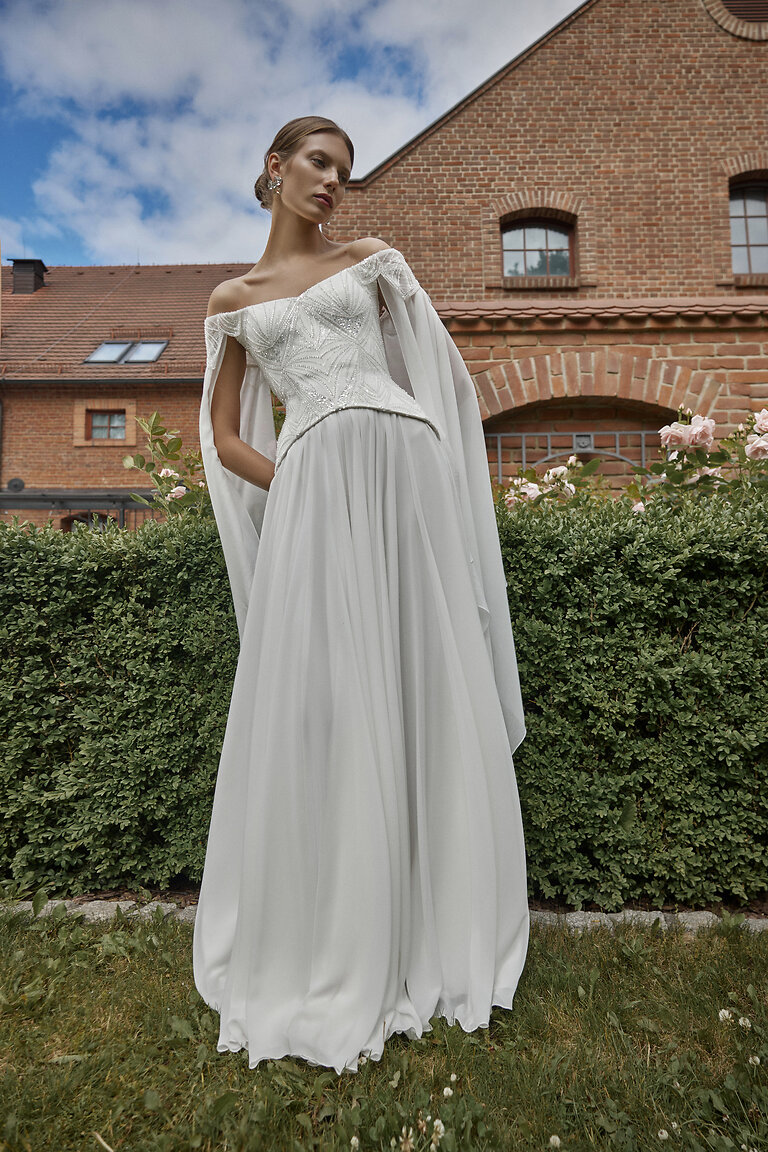 Elegant Ivory Bridal Set with Chiffon Sleeves Ivory Leona bridal set by Unona featuring beaded corset off-the-shoulder chiffon sleeves and A-line skirt