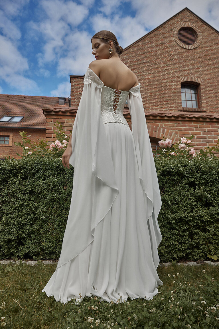 Boho Wedding Dress Leona Back View Full length back view of Unona Leona boho bridal gown with lace-up corset and flowing A-line chiffon skirt