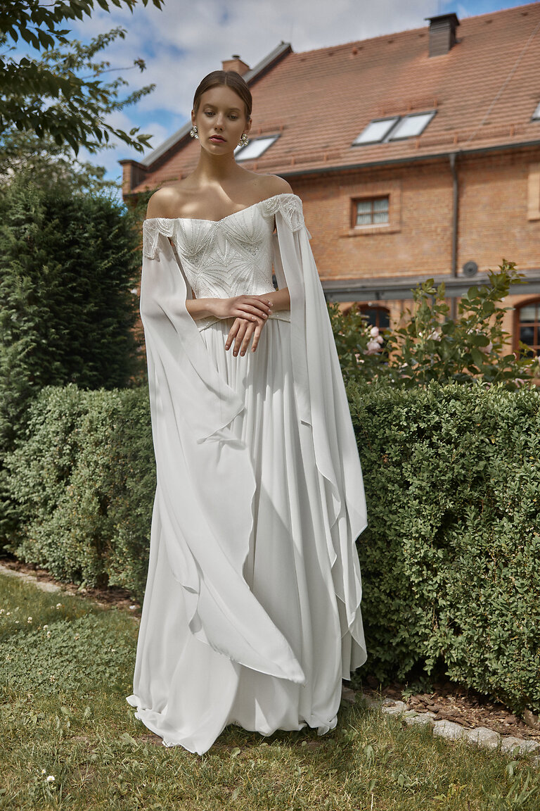 Detailed Beaded Corset Bridal Gown Leona Close front view of Leona ivory bridal set showing embellished off-the-shoulder corset and long draped sleeves