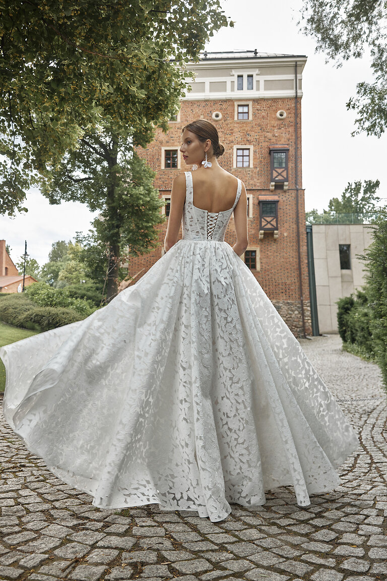 Romantic Lace-Up Corset Back on Ruta Bridal Gown Back view of Ruta off-white lace wedding dress featuring an open square back and lace-up corset detail