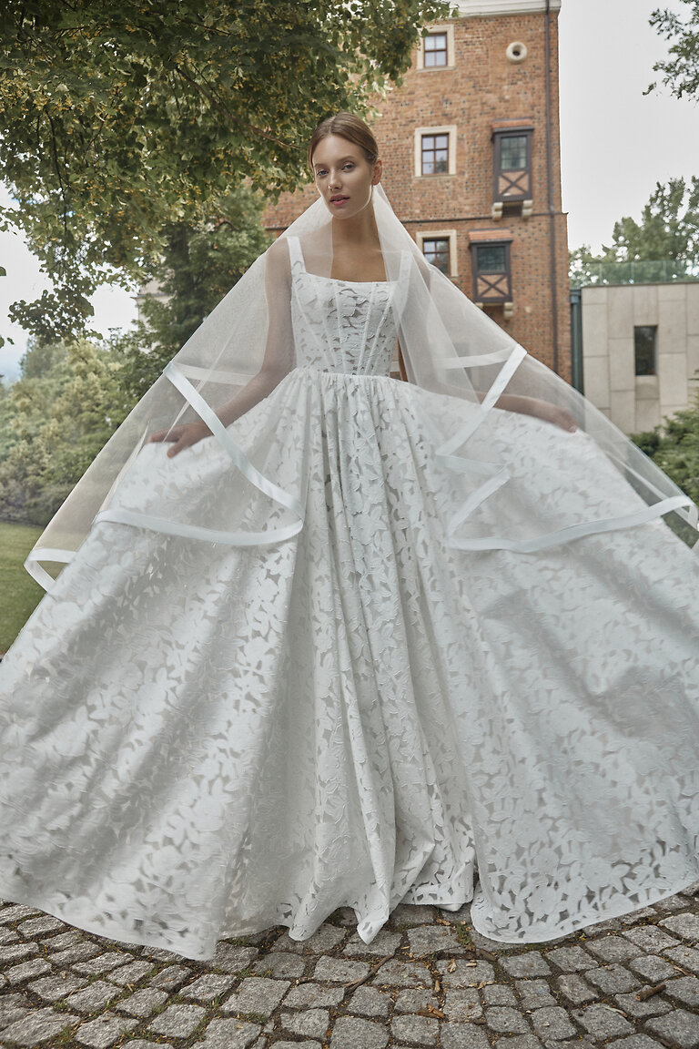 Bridal Look Styled with Wide Ribbon-Trimmed Veil Ruta off-white floral lace wedding gown styled with ribbon-trimmed sheer bridal veil
