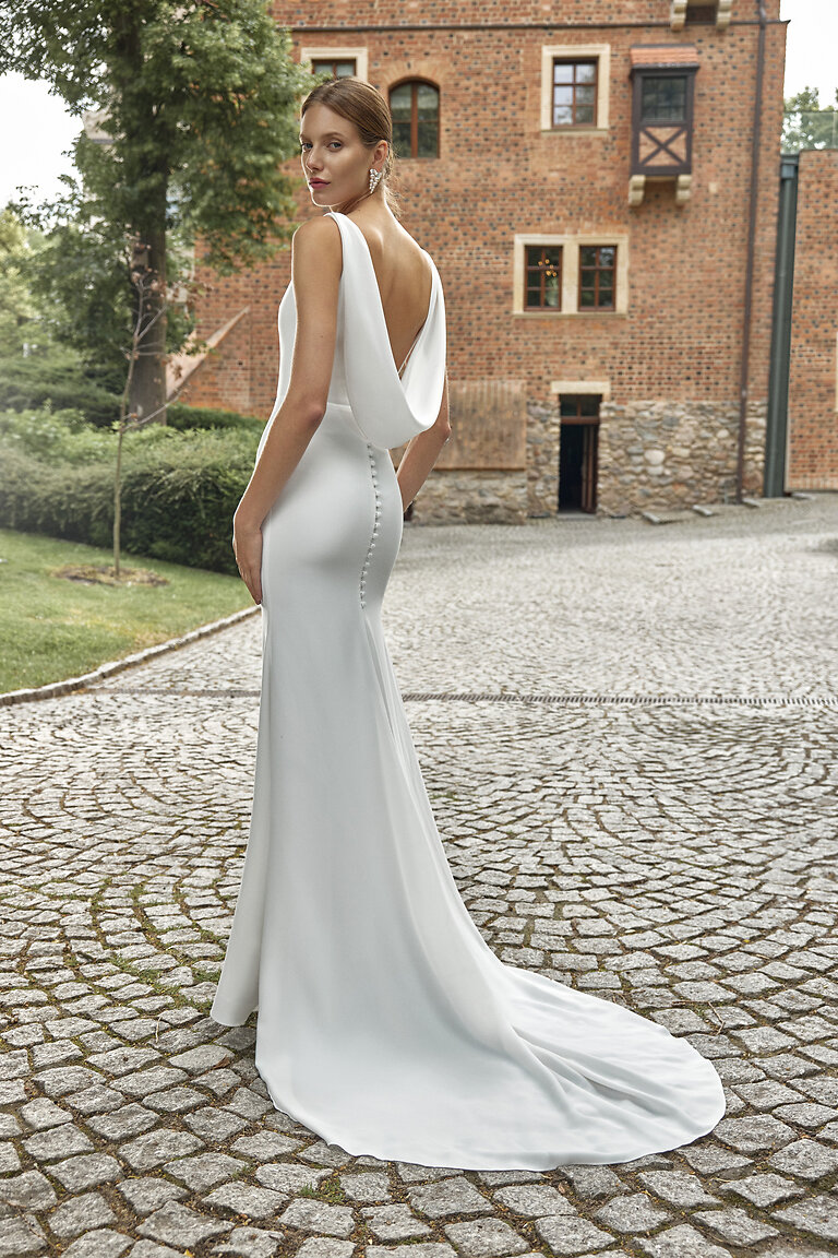 Back side view of Paola ivory crepe wedding dress with open cowl back and chapel train